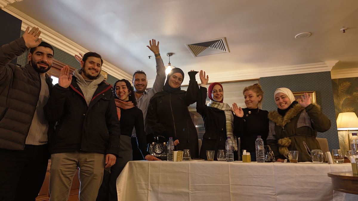 OSM Syria community members waving at the third meeting in Damascus