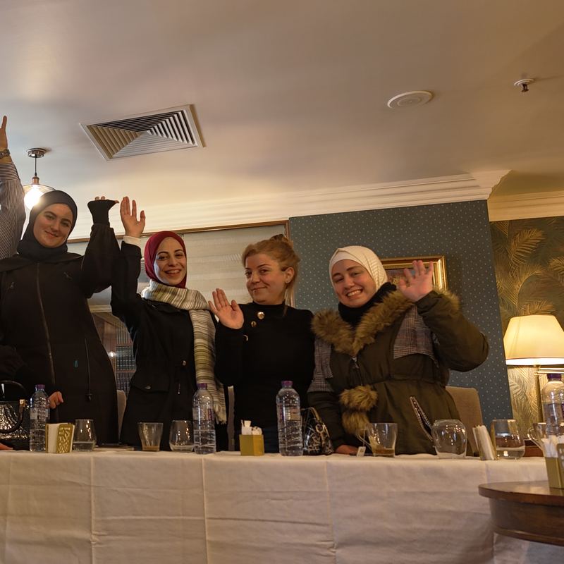 Community members waving at the third meeting in Damascus