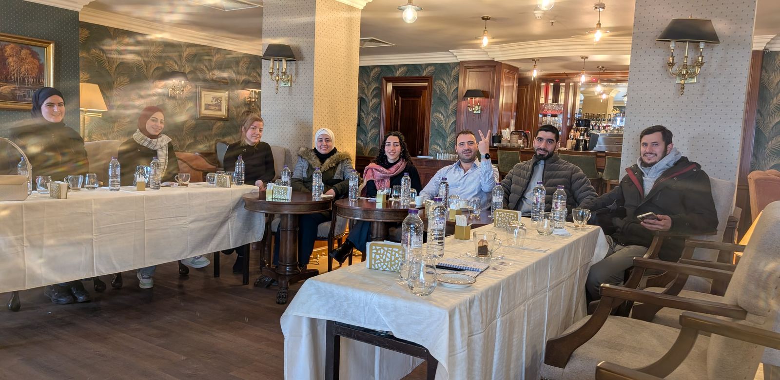 Community members around the table at the third meeting in Damascus, December 2025