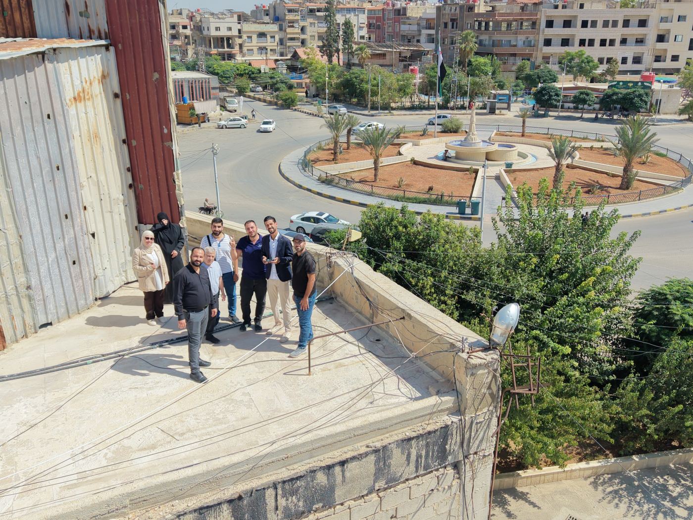 The workshop team on a rooftop in Douma, photographed from a drone