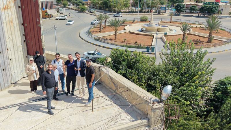 The workshop team on a rooftop in Douma, photographed from a drone